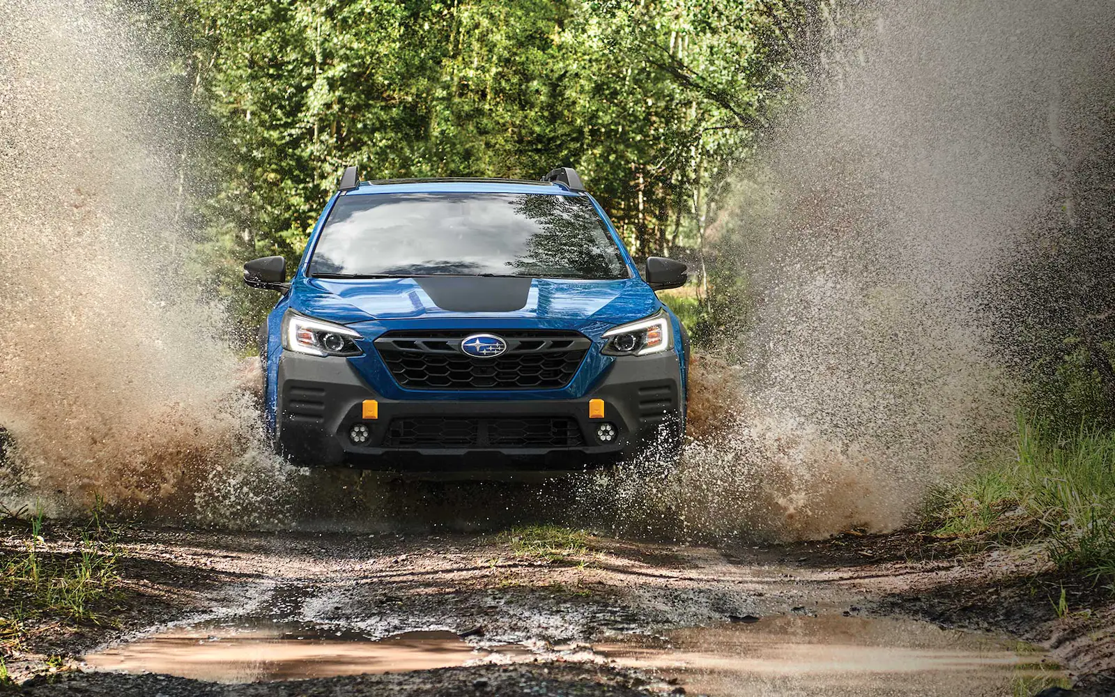 2022 Outback Wilderness in Geyser Blue parked on a rocky road.